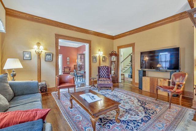 living room with wood-type flooring and ornamental molding