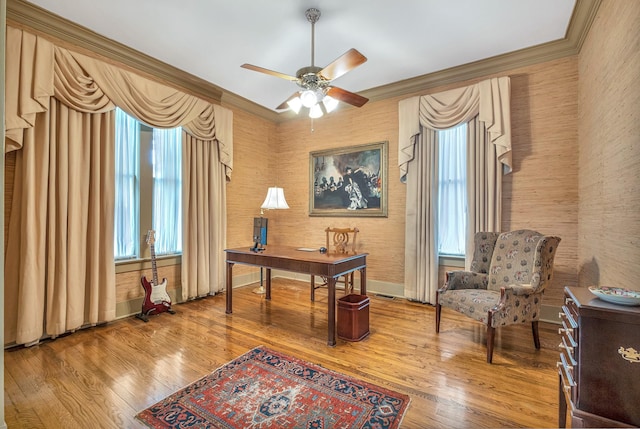 office featuring hardwood / wood-style floors, ceiling fan, and crown molding