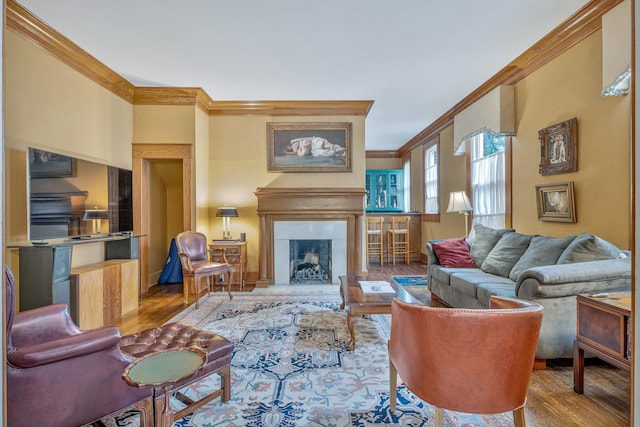 living room featuring hardwood / wood-style flooring and ornamental molding