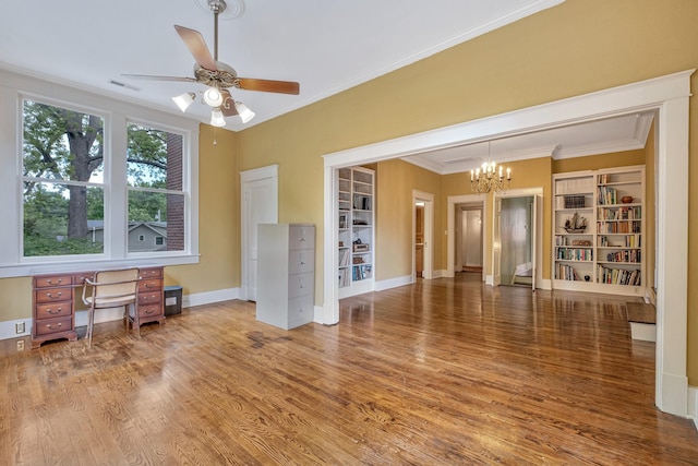 living room featuring hardwood / wood-style flooring, ceiling fan with notable chandelier, and crown molding