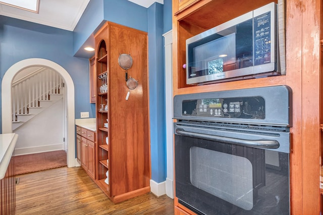 kitchen with light hardwood / wood-style floors and black oven