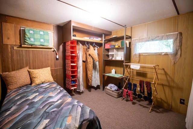 bedroom with wooden walls and carpet