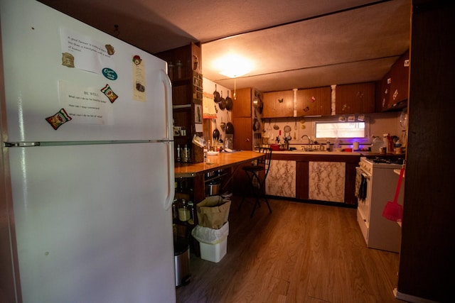 kitchen with white appliances and light wood-type flooring