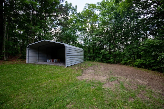 view of outbuilding featuring a carport and a yard