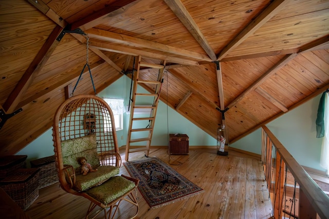 unfurnished room featuring light wood-type flooring, lofted ceiling with beams, and wooden ceiling