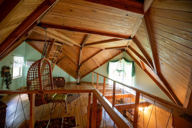 interior space with lofted ceiling with beams, hardwood / wood-style floors, and wooden ceiling