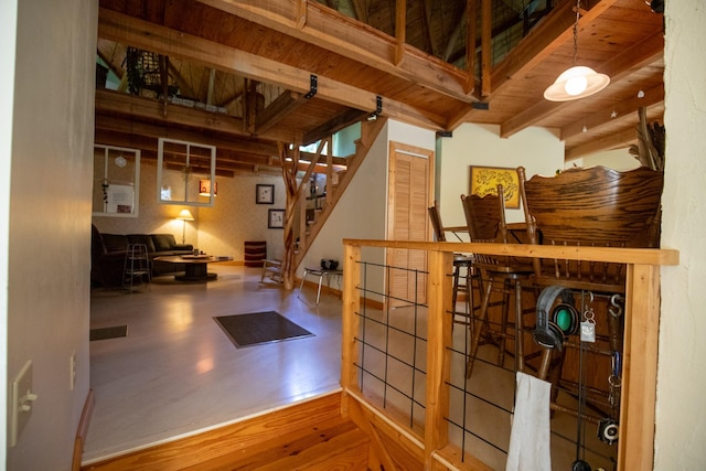 interior space featuring beam ceiling, hardwood / wood-style flooring, and wooden ceiling