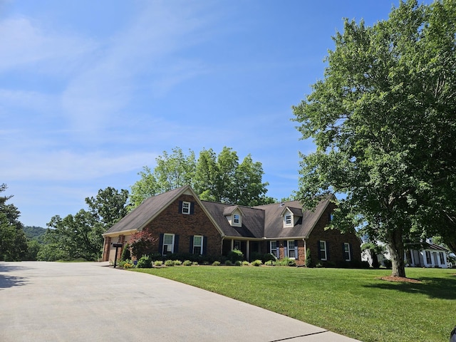 cape cod-style house with a front lawn