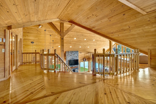 interior space with a healthy amount of sunlight, wood ceiling, light hardwood / wood-style flooring, and vaulted ceiling with beams