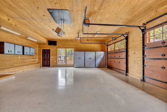 garage with wood ceiling, wooden walls, and a garage door opener