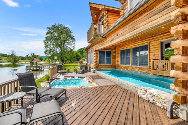 view of pool with a deck with water view