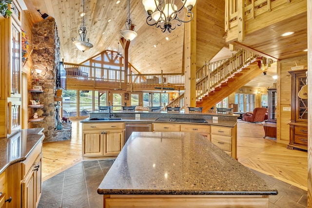 kitchen with hanging light fixtures, a center island, wooden ceiling, and high vaulted ceiling