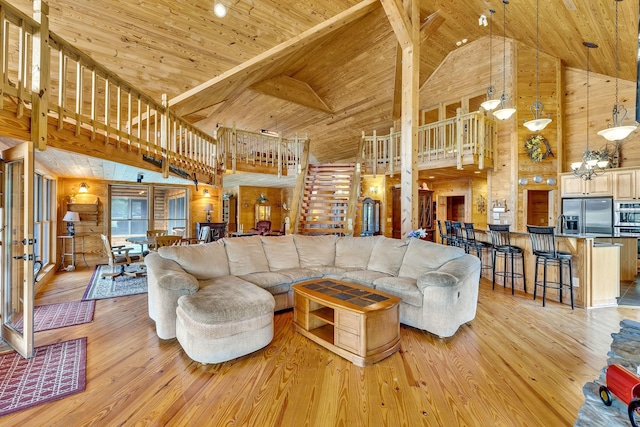 living room with wood ceiling, light hardwood / wood-style flooring, wooden walls, and high vaulted ceiling