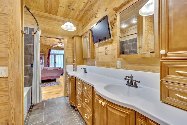 bathroom featuring wood ceiling, tile patterned flooring, vanity, ceiling fan, and wooden walls