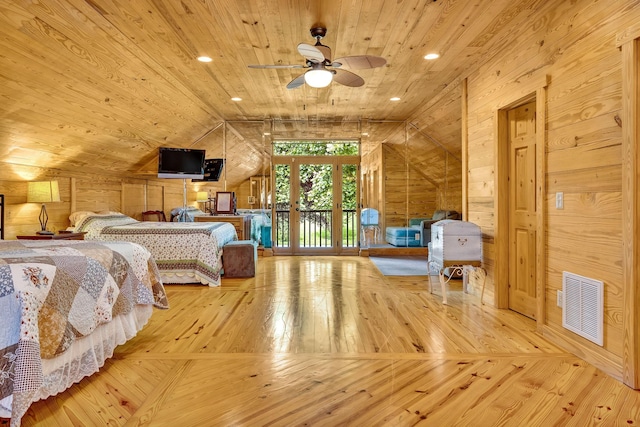 bedroom featuring wood ceiling, hardwood / wood-style floors, wood walls, ceiling fan, and lofted ceiling