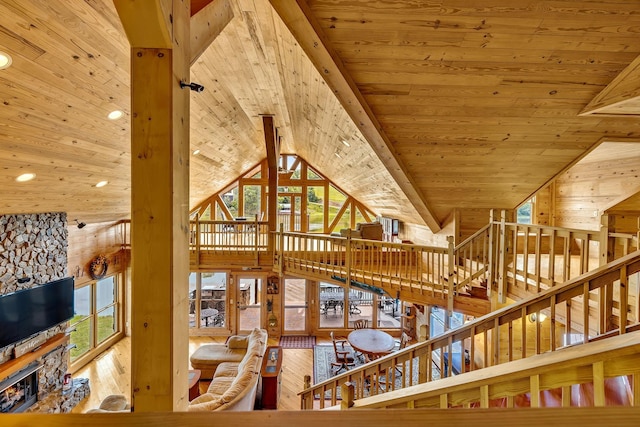 interior space featuring beamed ceiling, wooden walls, wooden ceiling, and hardwood / wood-style floors