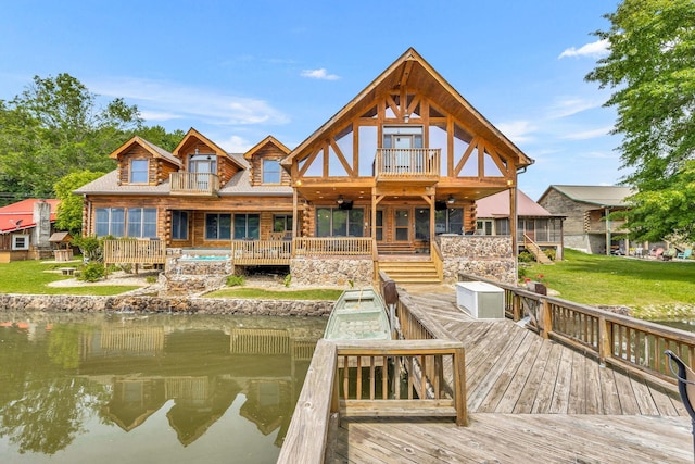 rear view of property featuring a balcony and a deck with water view