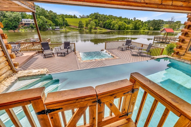 view of pool with a deck with water view and a hot tub