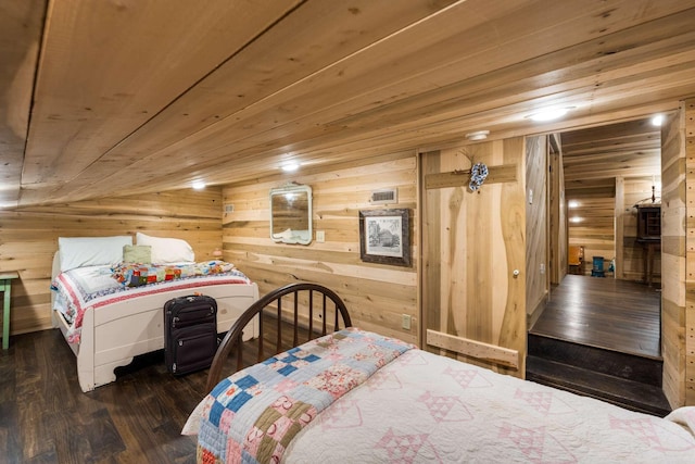 bedroom with dark hardwood / wood-style floors, wood ceiling, and wood walls