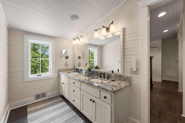 bathroom with hardwood / wood-style flooring, wooden ceiling, vanity, and wood walls