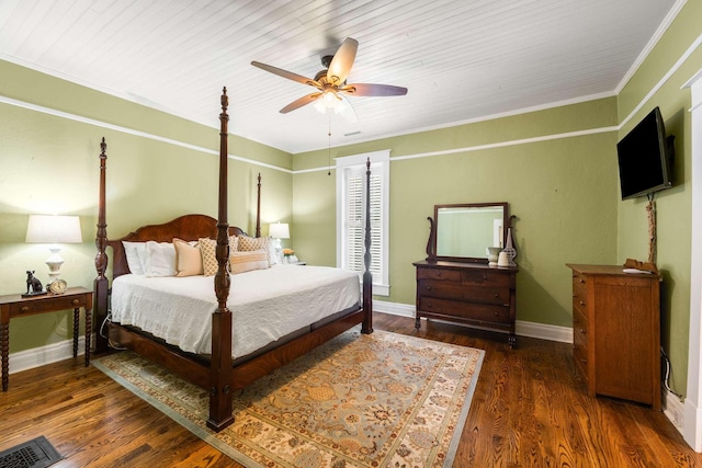 bedroom with crown molding, dark wood-type flooring, and ceiling fan