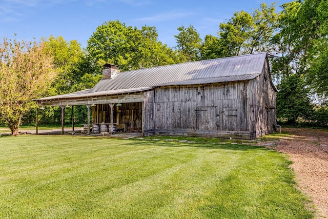 view of outdoor structure featuring a lawn