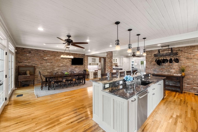 kitchen featuring brick wall, sink, pendant lighting, and wood ceiling