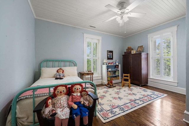 bedroom with crown molding, ceiling fan, and dark hardwood / wood-style floors