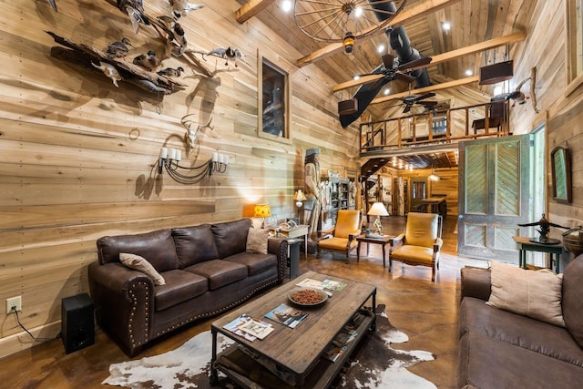 living room featuring concrete flooring, wood ceiling, high vaulted ceiling, wooden walls, and beamed ceiling