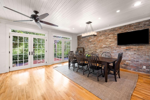 dining room with french doors, ornamental molding, brick wall, and light hardwood / wood-style flooring