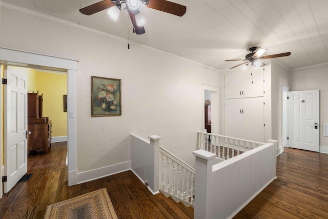 corridor featuring ornamental molding and dark hardwood / wood-style flooring