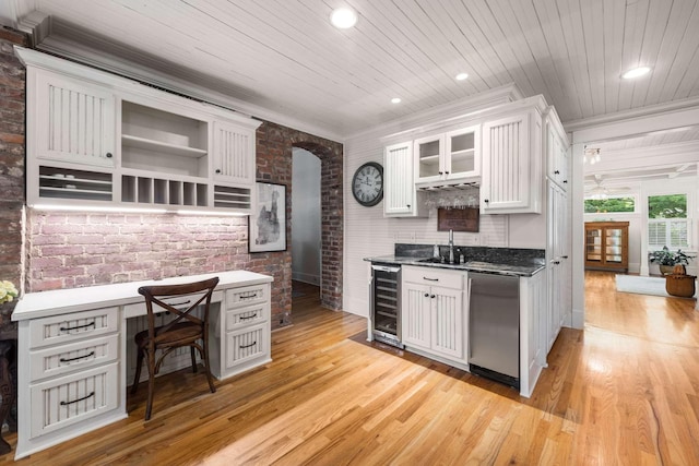 kitchen with white cabinetry, wooden ceiling, light wood-type flooring, brick wall, and beverage cooler