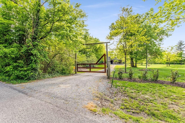 view of gate featuring a lawn