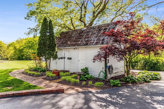 view of outbuilding with a yard