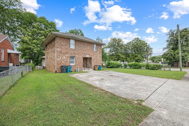 back of property featuring a lawn and a patio area