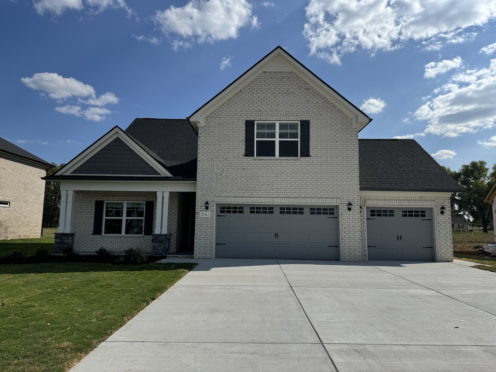 view of front of property with a garage and a front lawn