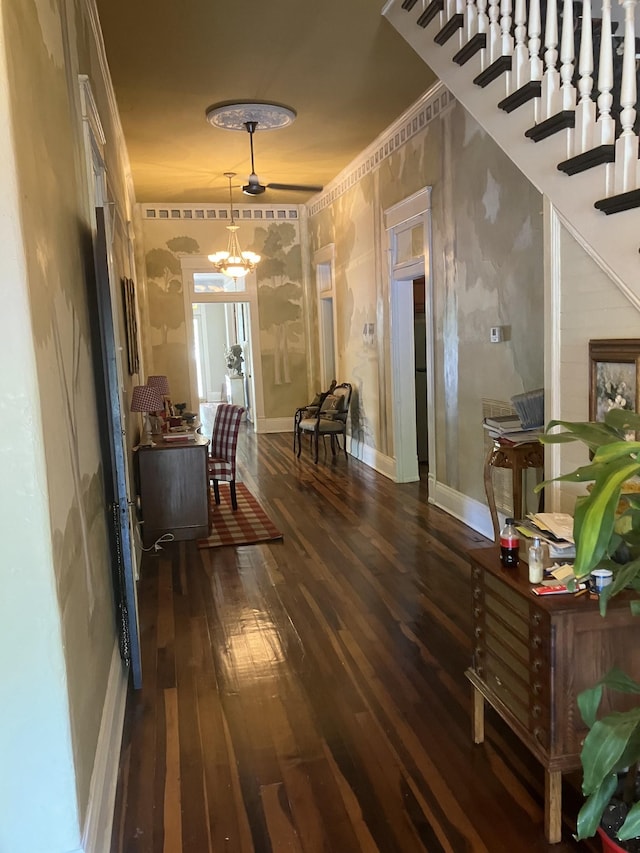 hallway featuring ornamental molding, dark hardwood / wood-style flooring, and a notable chandelier