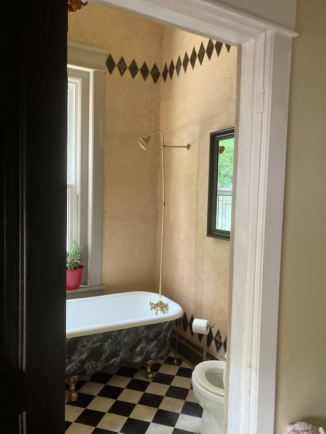 bathroom featuring a bathtub and toilet