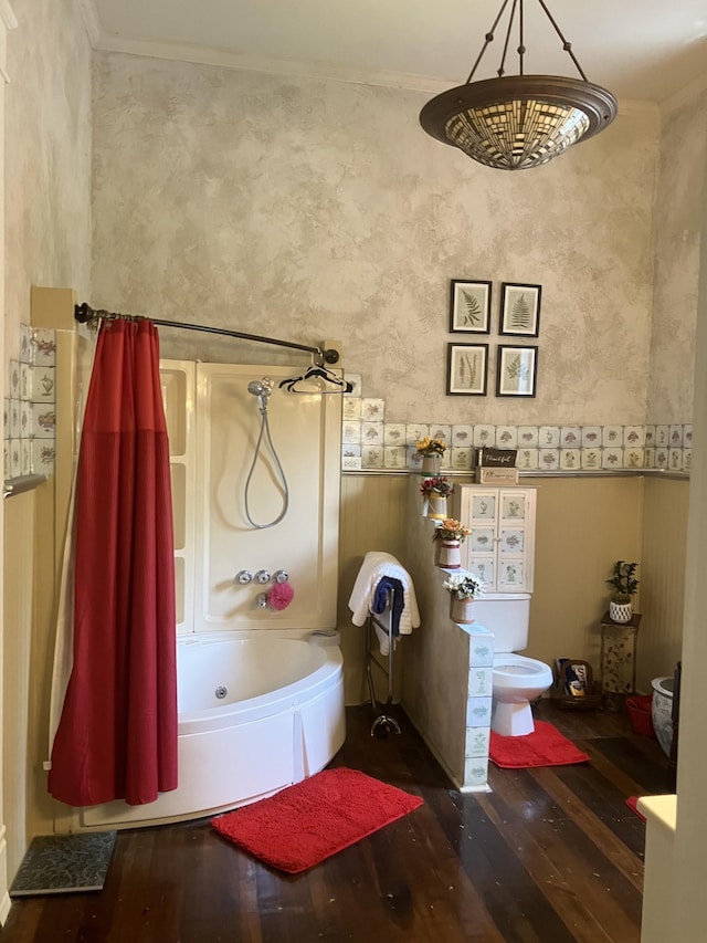 bathroom featuring toilet, hardwood / wood-style floors, crown molding, and shower / bath combo