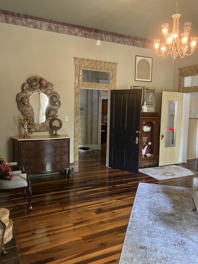 entrance foyer featuring dark hardwood / wood-style floors and a notable chandelier