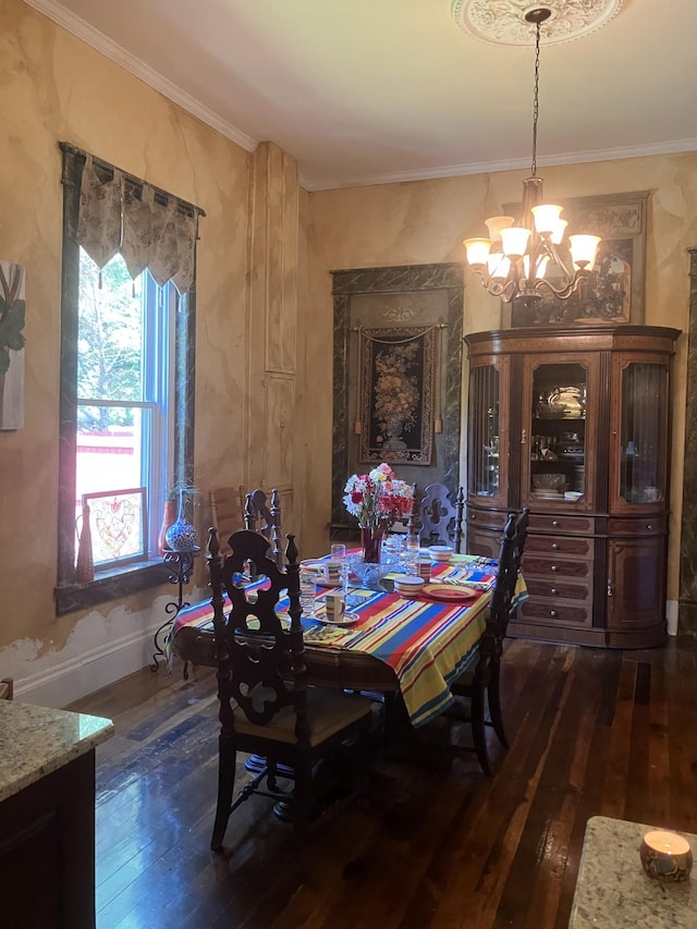 dining area with a notable chandelier, dark hardwood / wood-style flooring, and ornamental molding