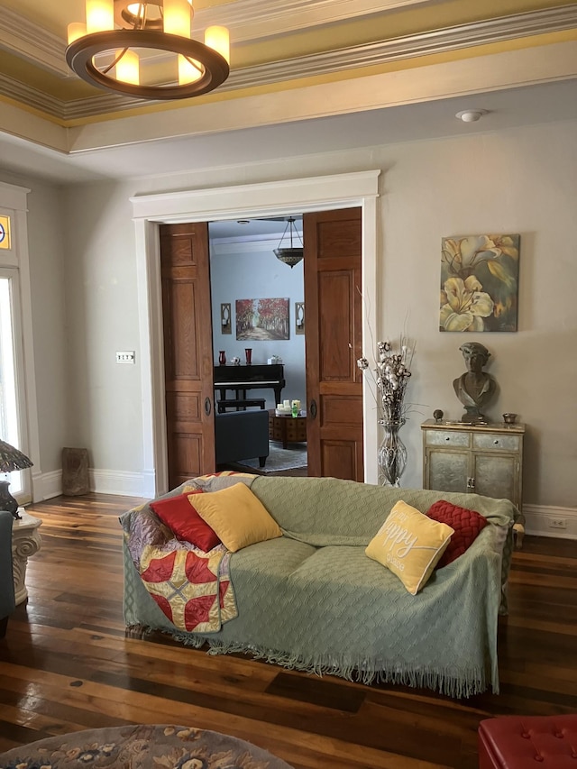 bedroom featuring dark hardwood / wood-style flooring, a raised ceiling, and ornamental molding