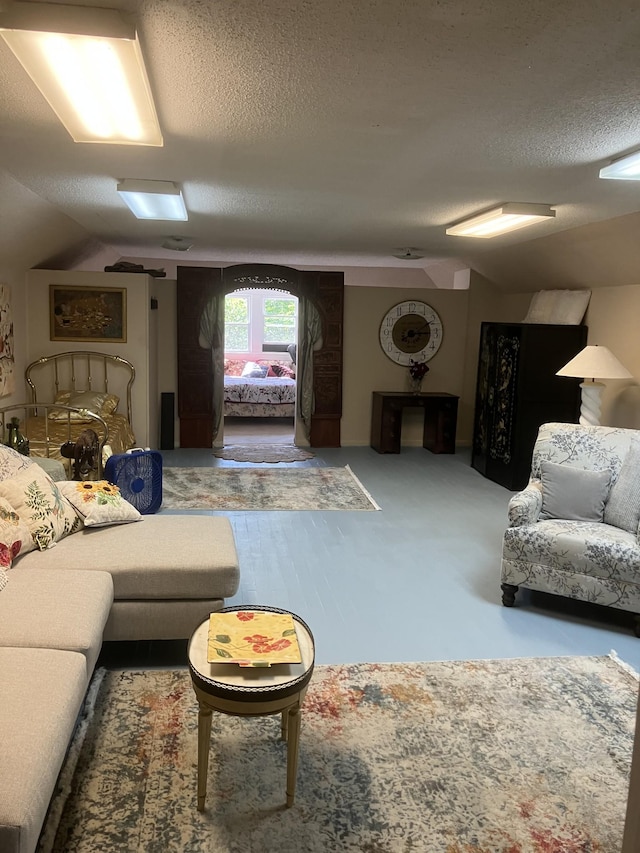 living room with lofted ceiling and a textured ceiling