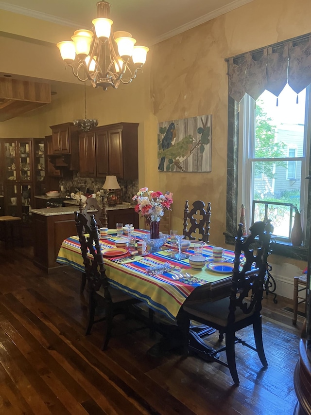 dining room featuring crown molding, dark hardwood / wood-style flooring, and a chandelier