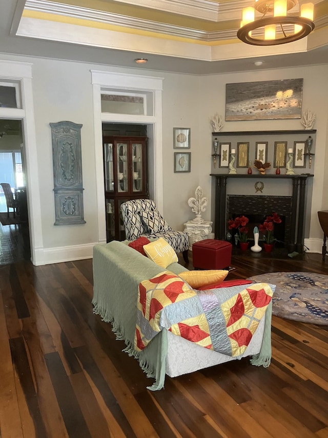 interior space with a tray ceiling, crown molding, and dark hardwood / wood-style flooring