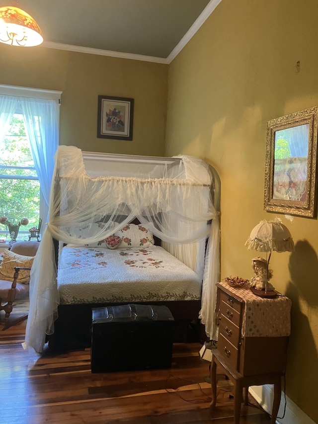 bedroom featuring dark hardwood / wood-style flooring and ornamental molding