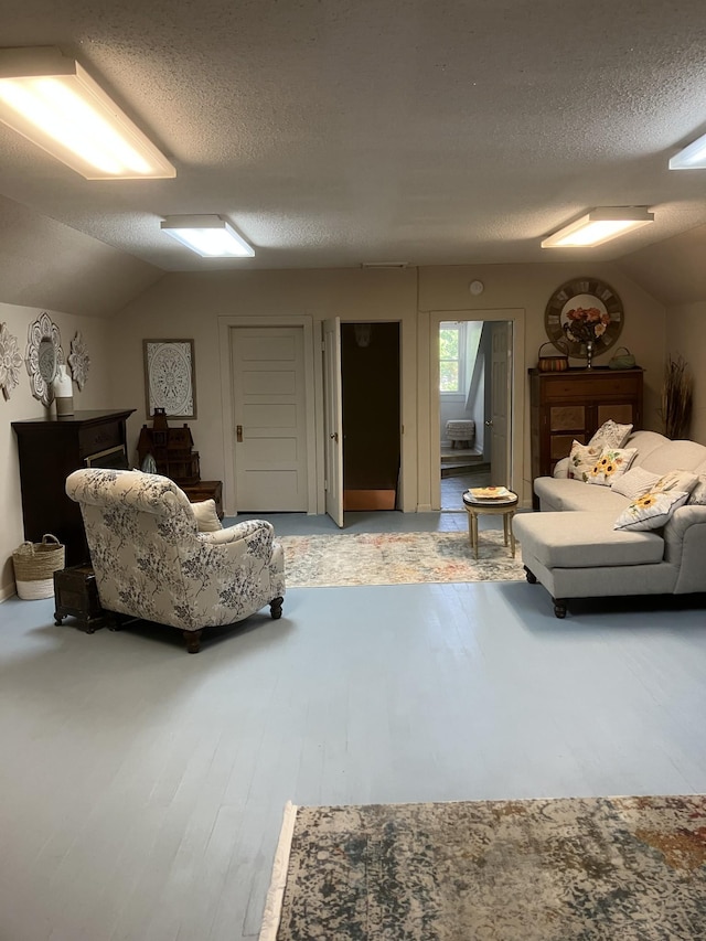 bedroom with a textured ceiling and lofted ceiling