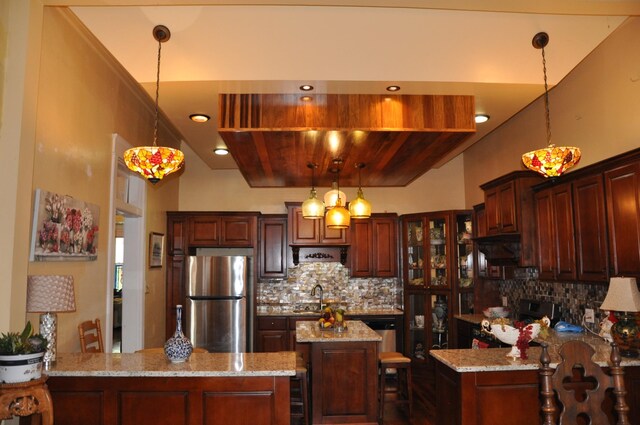 kitchen with wooden ceiling, backsplash, hanging light fixtures, stainless steel fridge, and kitchen peninsula