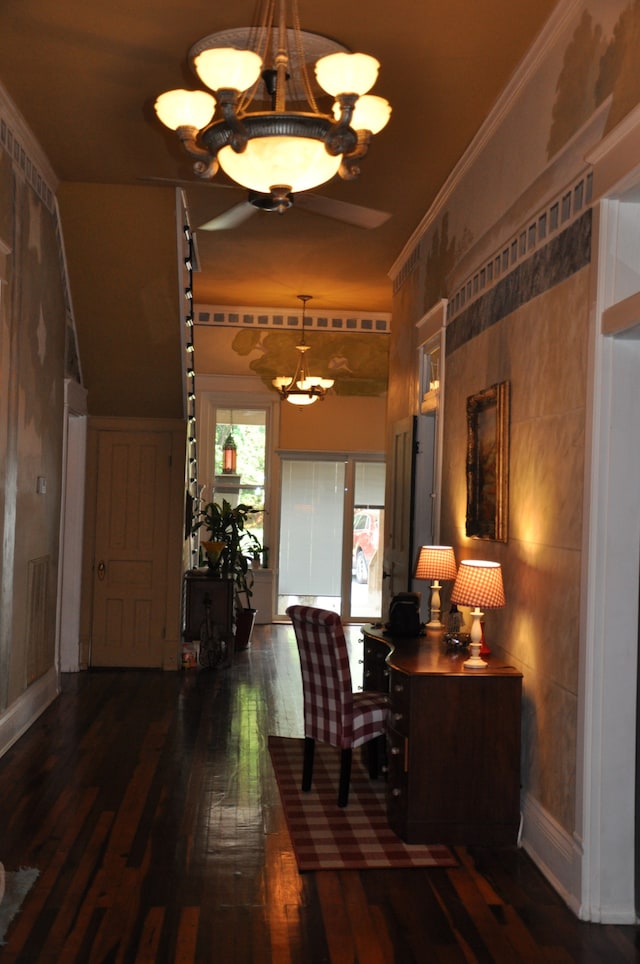 interior space featuring a notable chandelier, dark hardwood / wood-style floors, and crown molding