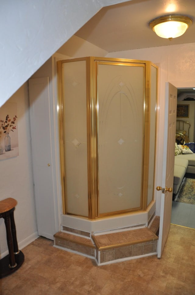 ensuite bathroom with ensuite bath, vaulted ceiling, and a shower stall